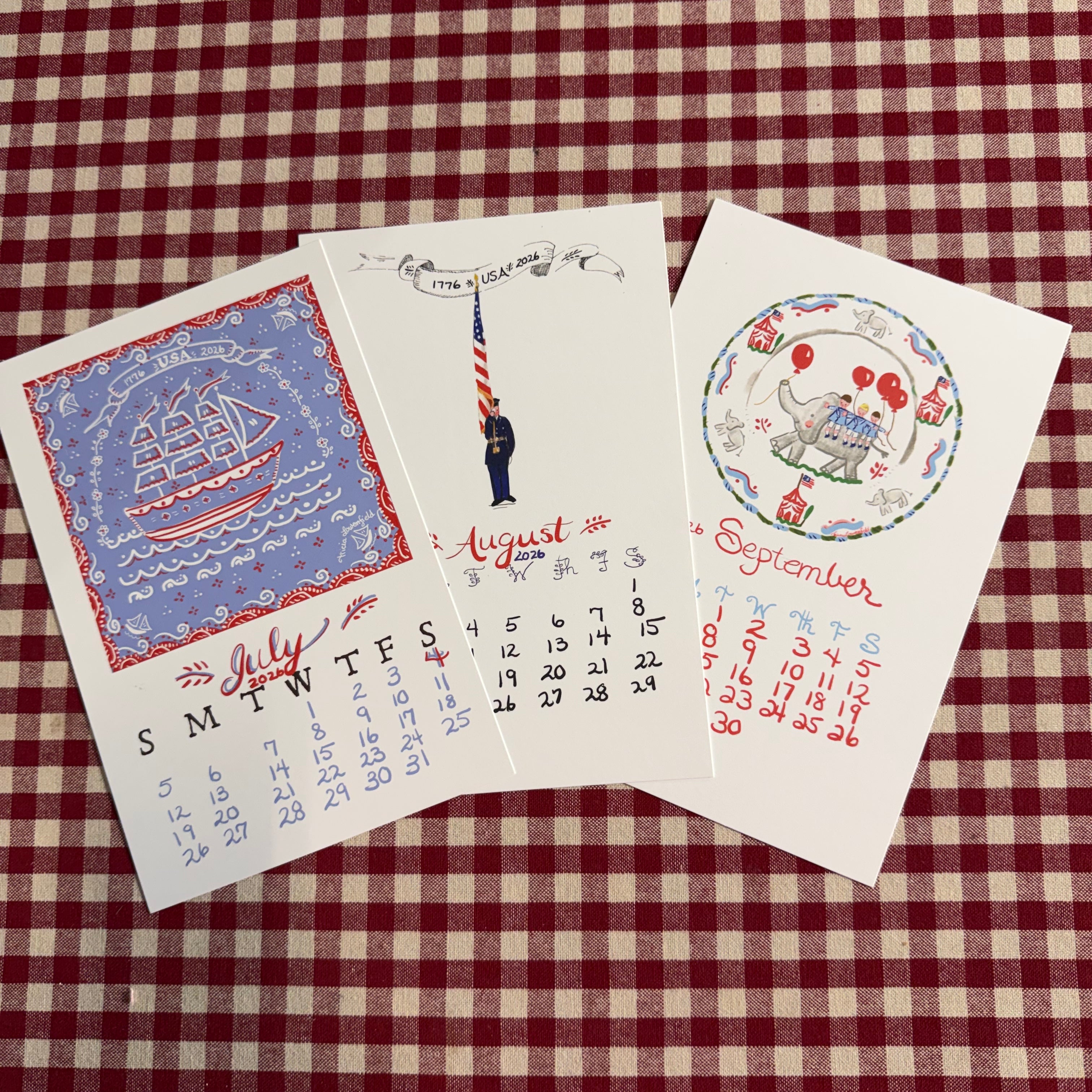 Three postcards with different designs on a red and white checkered background