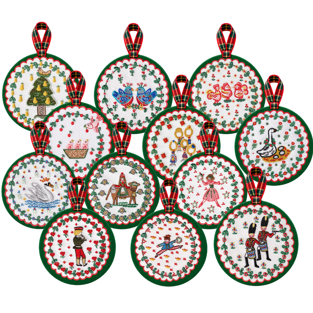 A set of 12 round embroidered Christmas ornaments with red and green plaid hanging tabs, displayed on a plain white background.